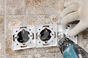 An electrician is installing switches and sockets