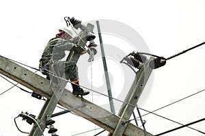 Electrician lineman repairman worker at climbing work