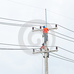 Electrician lineman repairman worker at climbing work