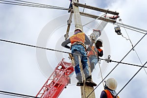 Electrician lineman repairman worker at climbing work on electric post power pole