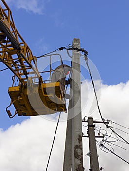 Work on electric post power pole Electrician lineman repairman worker at climbing