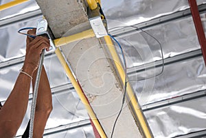 Electrician male working install wire power cable . professional technician worker setting connect electric metal box on ceiling