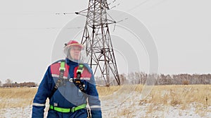Electrician man mounting electric voltage wires on the power line