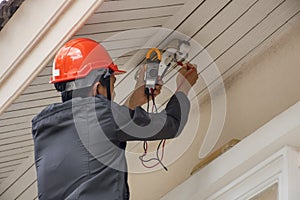 Electrician man using multimeter