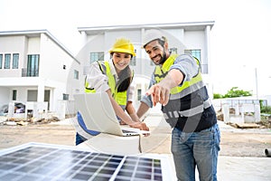 electrician man and woman in safety vest with helmet use laptop for check solar cell plant. Green energy electricity. concept of s