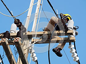 Electrician man working at height and dangerous ,high voltage power line