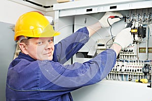 Electrician measure voltage with multimeter photo