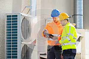 An Electrician Men Checking Air Conditioning Unit