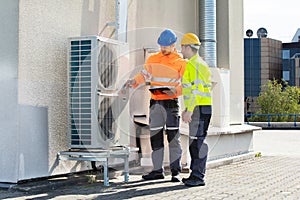 An Electrician Men Checking Air Conditioning Unit