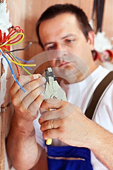 Electrician peeling wire endings