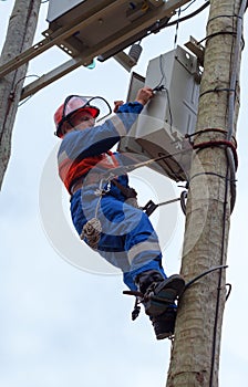 Electrician perform maintenance on the transmission towers recloser