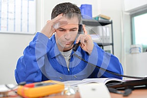 Electrician on phone in office