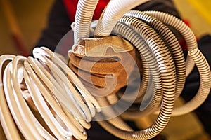 Electrician with Plastic Electric System Conduits in His Hands