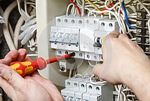 Electrician professional working on electric equipment installation and cheking