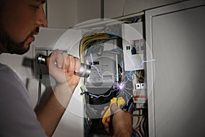 Electrician receiving electric shock while working