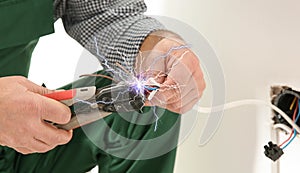 Electrician receiving electric shock while working