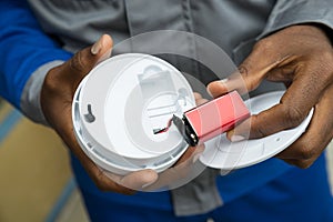 Electrician Removing Battery From Smoke Detector