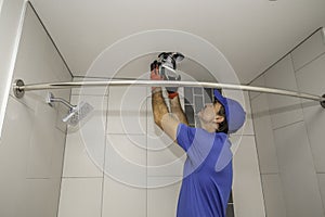 Electrician removing a light fixture