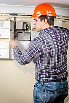 Electrician repairing electrical board at home