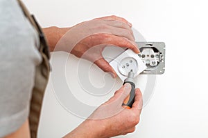 Electrician repairing socket