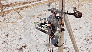 Electrician repairman working on tower at the electric station