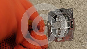 Electrician Repairs A Wall Light Switch