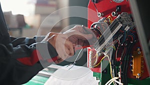 Electrician`s hands installing energy system on machinery industry