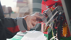 Electrician`s hands installing energy system on machinery industry