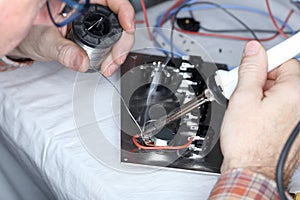 Electrician is soldering components