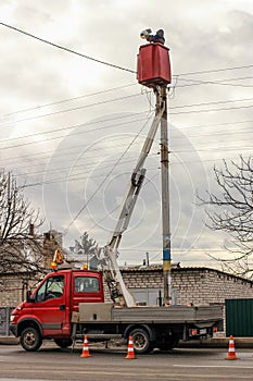 Electrician technician on the bucket of the truck aerial platform