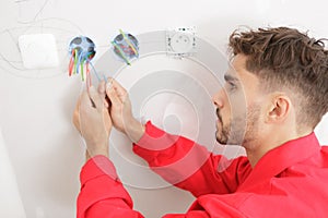 electrician technician fixes cables in site