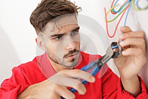 Electrician technician fixes electric cable socket