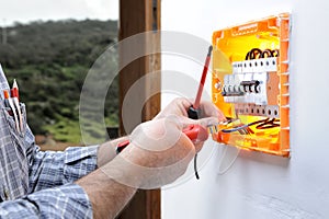 Electrician technician repairs the electrical panel of a residential system