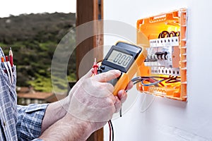 Electrician technician repairs the electrical panel of a residential system