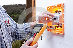 Electrician technician repairs the electrical panel of a residential system