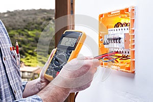 Electrician technician repairs the electrical panel of a residential system