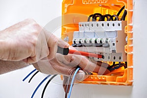 Electrician technician at work on a residential electric panel