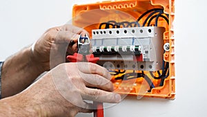 Electrician technician at work on a residential electric panel.