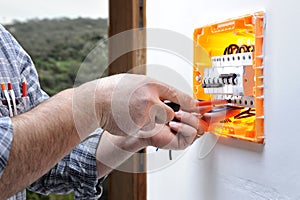 Electrician technician repairs the electrical panel of a residential system