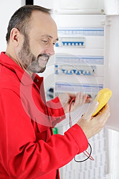 electrician technician at work on residential electrical panel