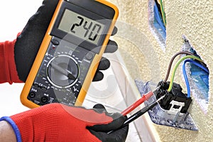 Electrician technician at work with safety equipment on a residential electrical system