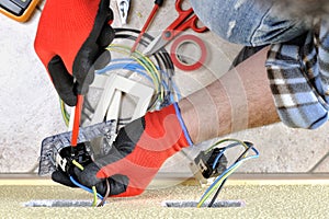 Electrician technician at work with safety equipment on a residential electrical system