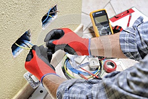 Electrician technician at work with safety equipment on a residential electrical system