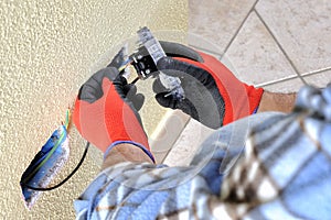 Electrician technician at work with safety equipment on a residential electrical system