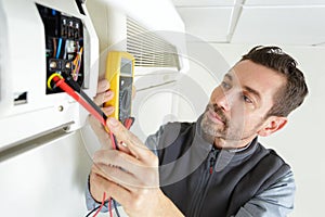 Electrician technician working on residential electrical panel