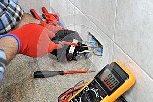 Electrician technician working safely on a residential electrical system.