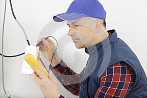 electrician testing cables with multimeter