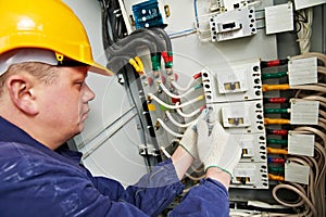 Electrician tighten the screws with spanner photo