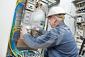 Electrician tighten the screws with spanner