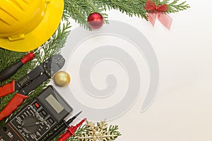 Electrician tools and instruments and Christmas decorations on white background
